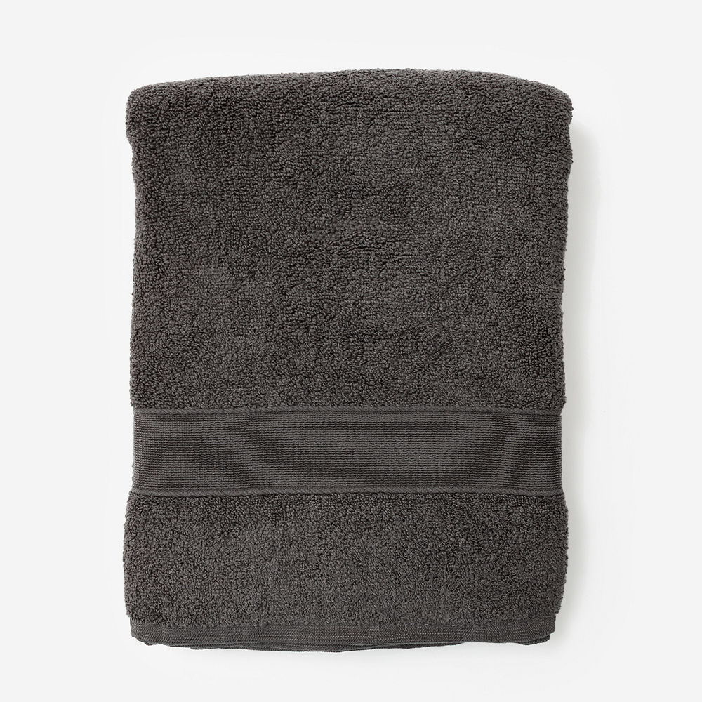 monogrammed bath towel in white hanging