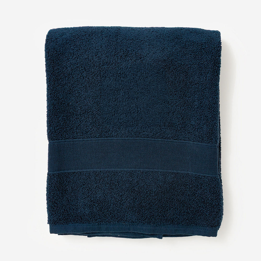 monogrammed bath towel in white hanging