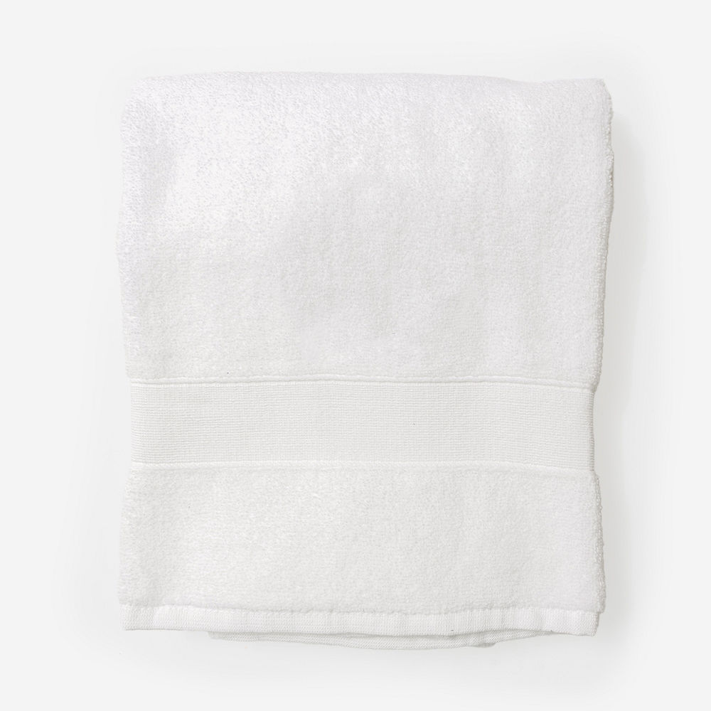 monogrammed bath towel in white hanging