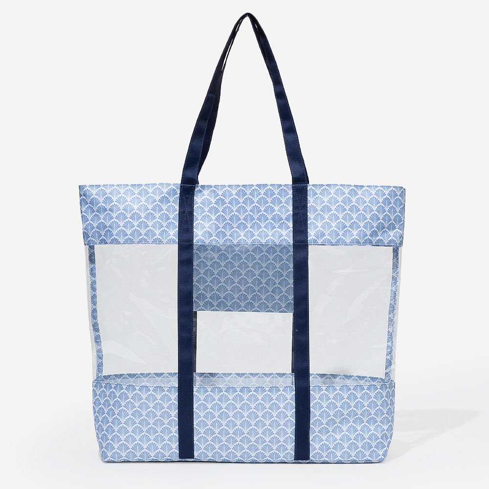 girl wearing blue shells clear beach tote on shoulder