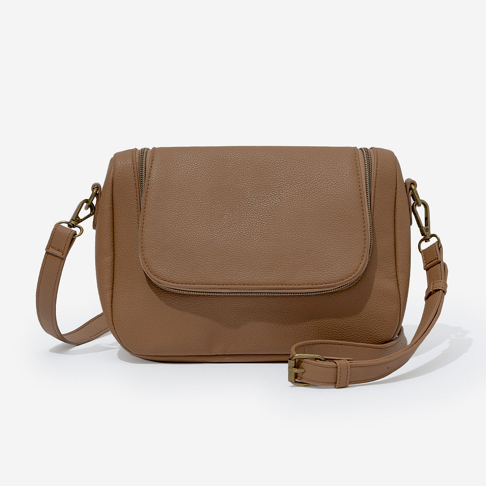 pockets in monogrammed crossbody bag in brown