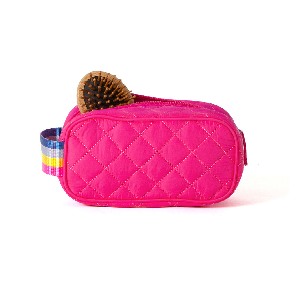 girl taking hairbrush out of kids quilted cosmetic case