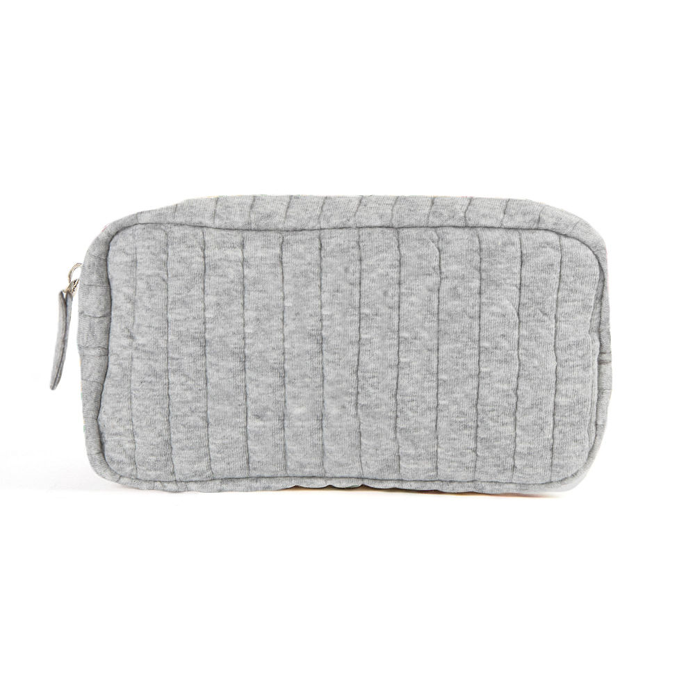 spill shot of gray quilted cosmetic case