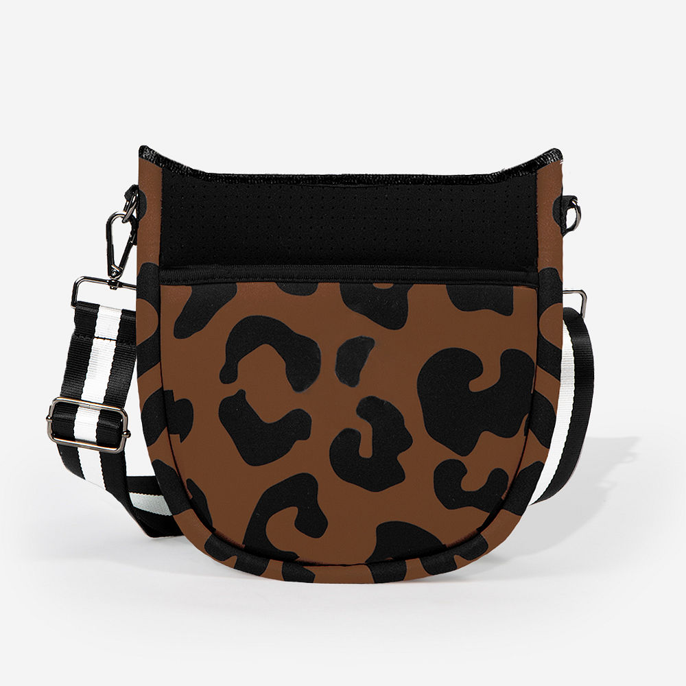 girl wearing hickory leopard crossbody with denim jacket