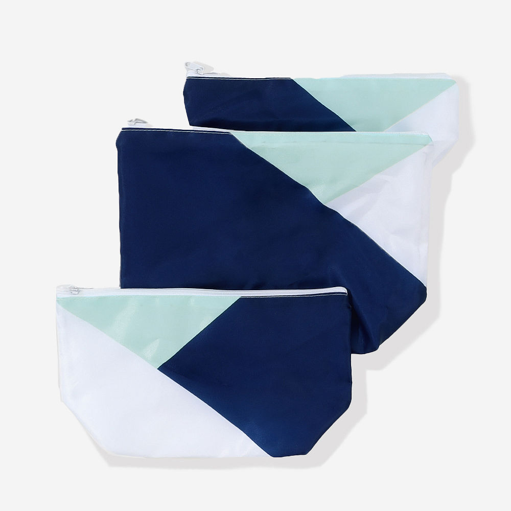 colorblock mint packable cosmetic bags on counter stacked
