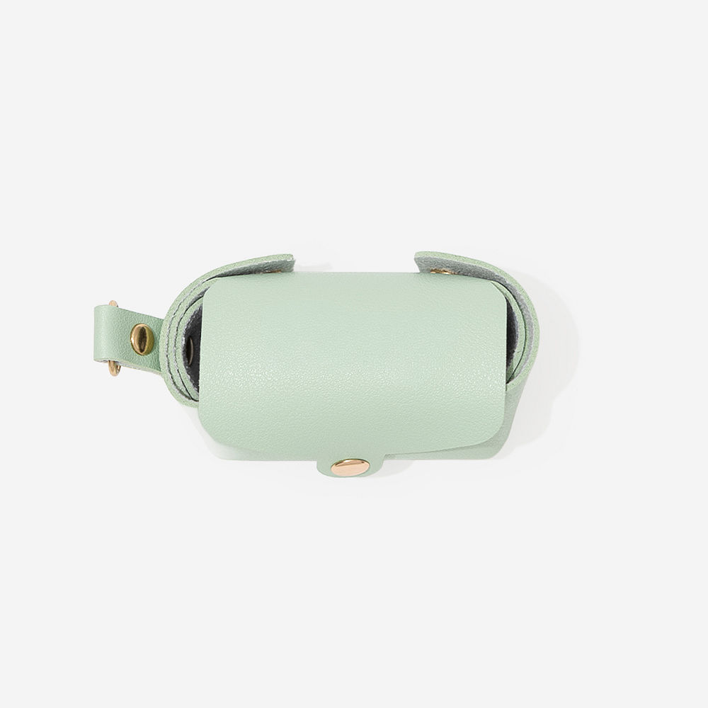girl holding pet waste bag holder with dog