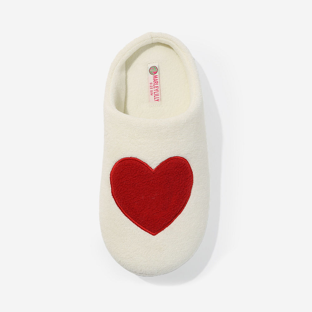 monogrammed slippers in ivory hearts with valentine day navy sweatshirt sitting