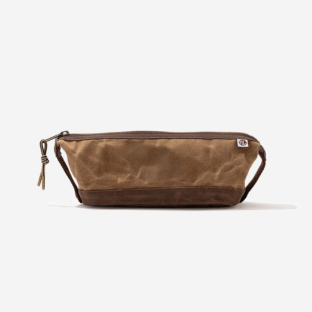 monogrammed waxed canvas dopp kit on bathroom counter