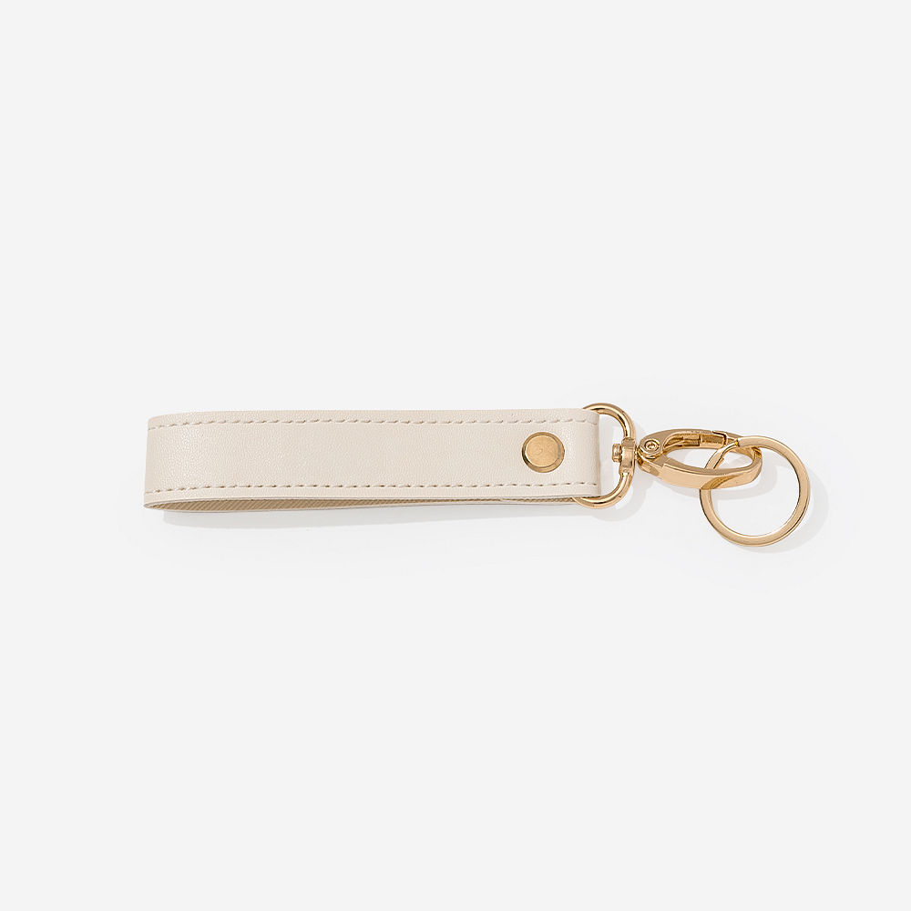 ivory classic keychain held up by bella