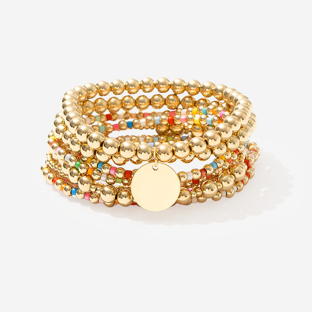 Colorful bracelet stack on purple