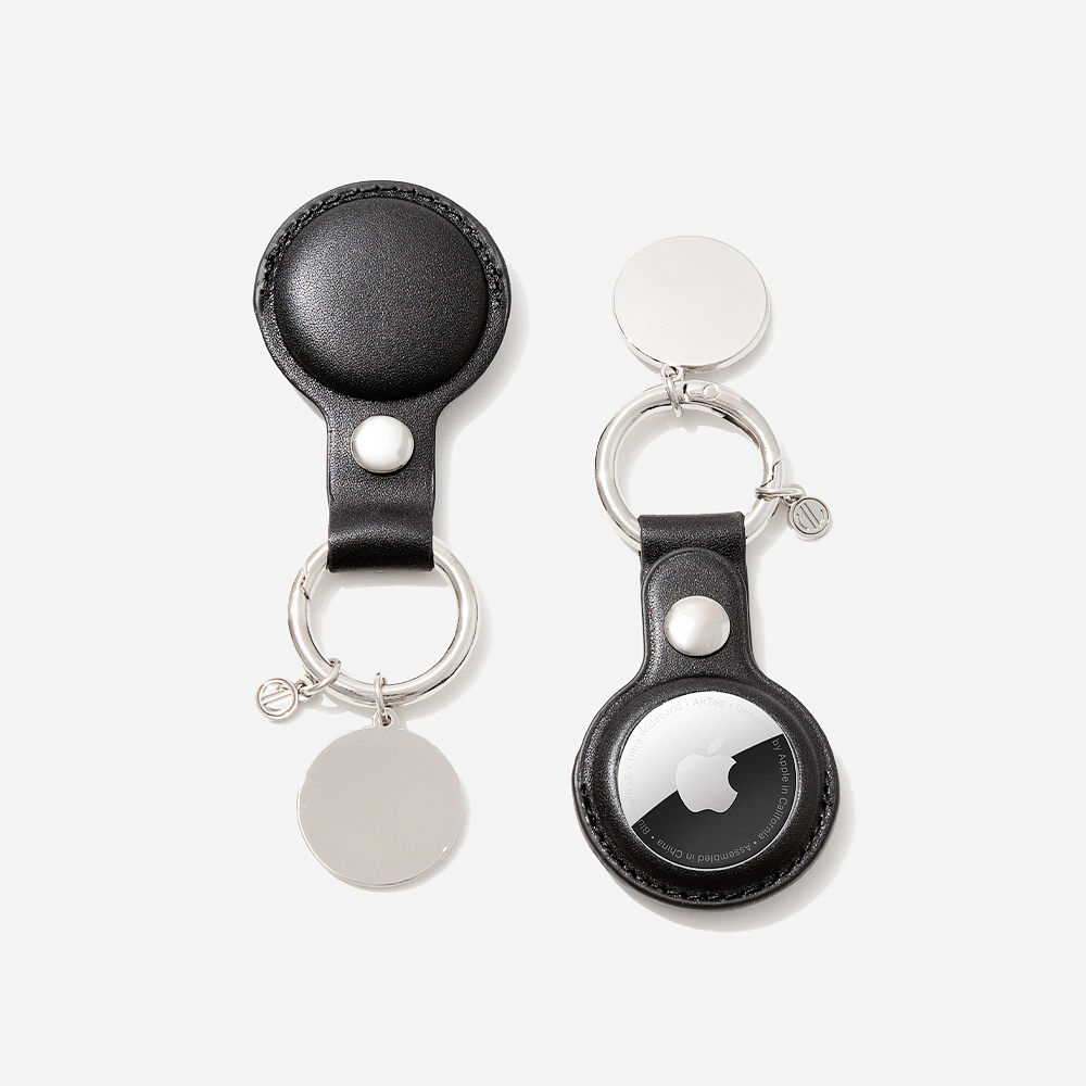 brown airtag key chain with seaside tote and hair clip