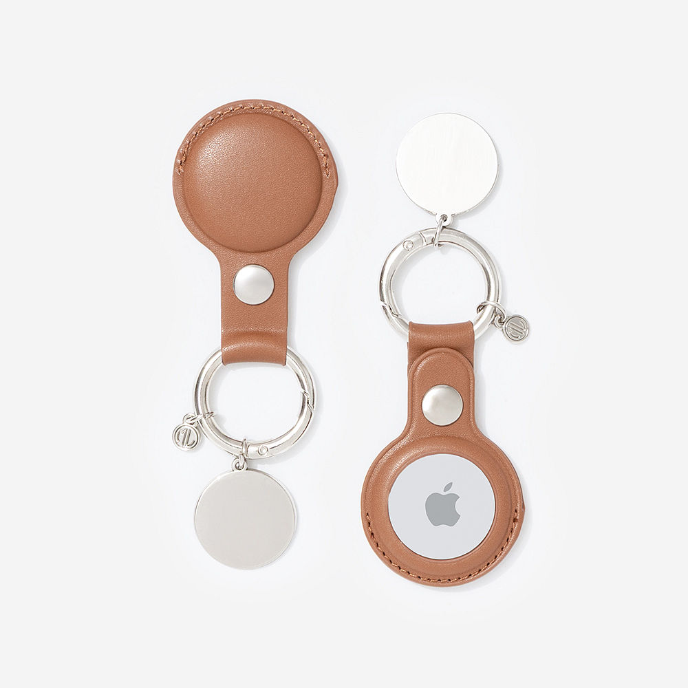 brown airtag key chain with seaside tote and hair clip