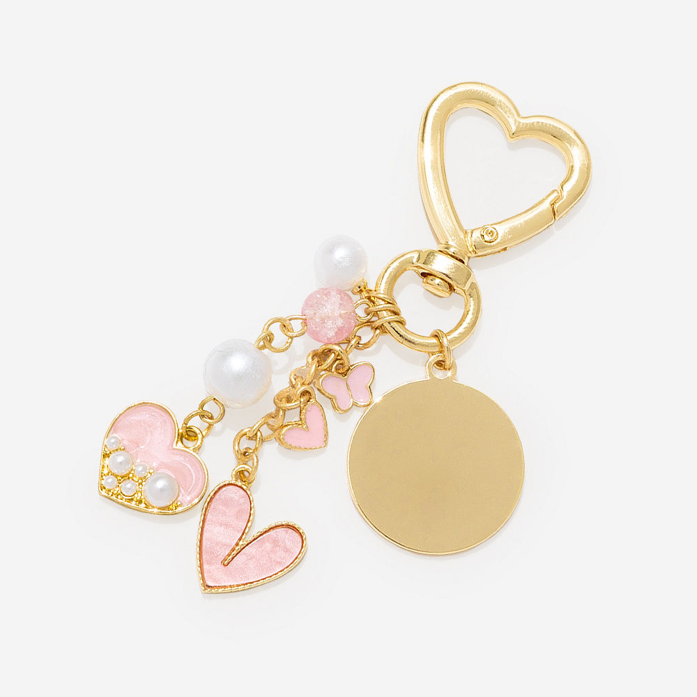 personalized gold bag charm keychain on shoulder bag