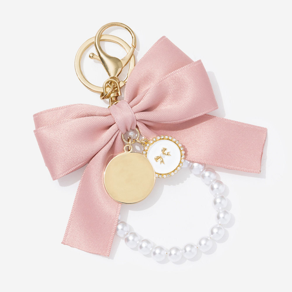 black monogrammed bag charm keychain on car keys