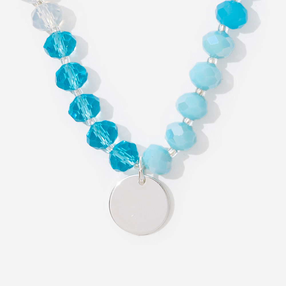 blue beaded necklace with white button down