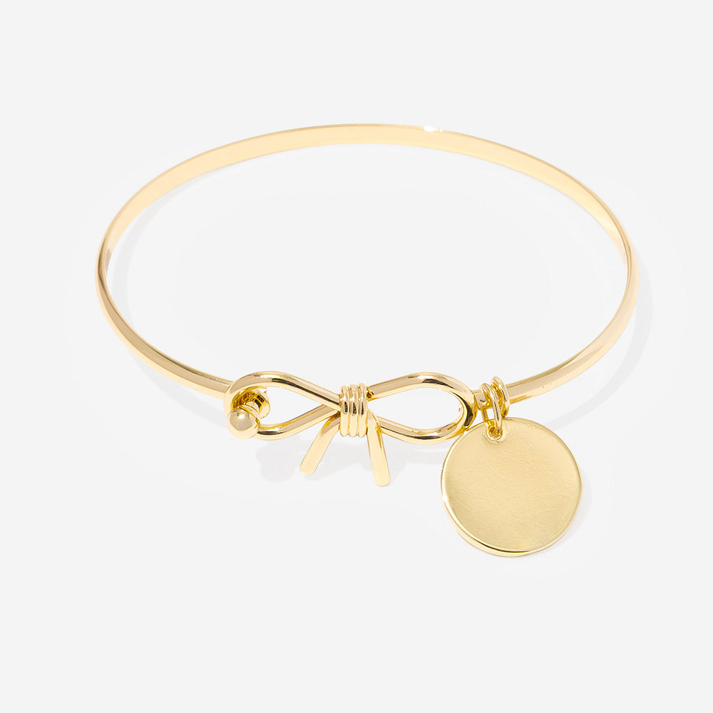 silver bow bangle on pink