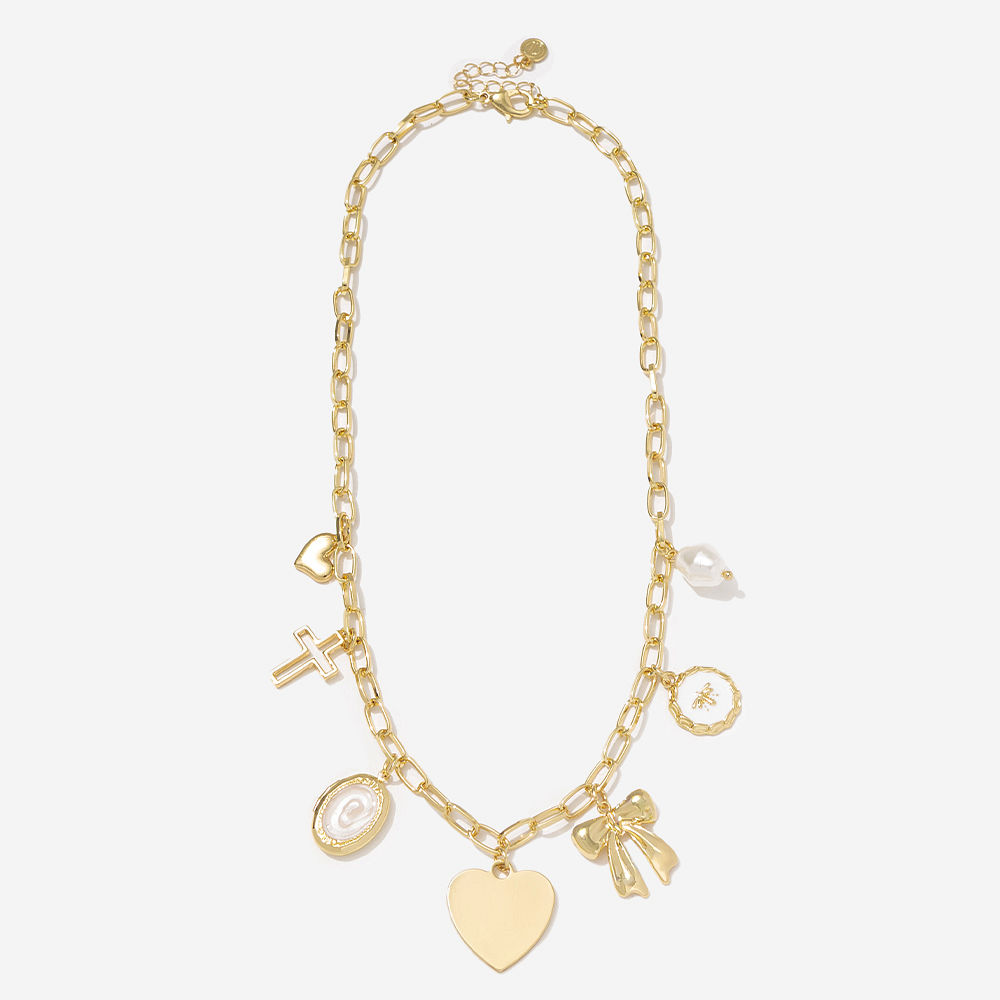 gold charm necklace on brown background