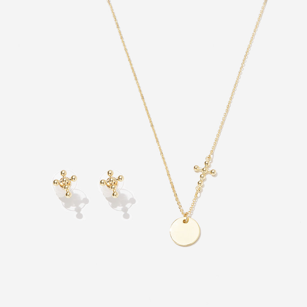 silver cross necklace on neck