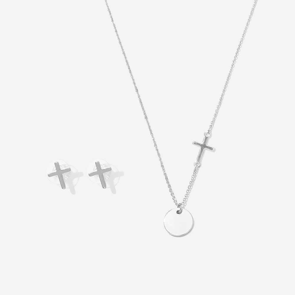silver cross necklace on neck