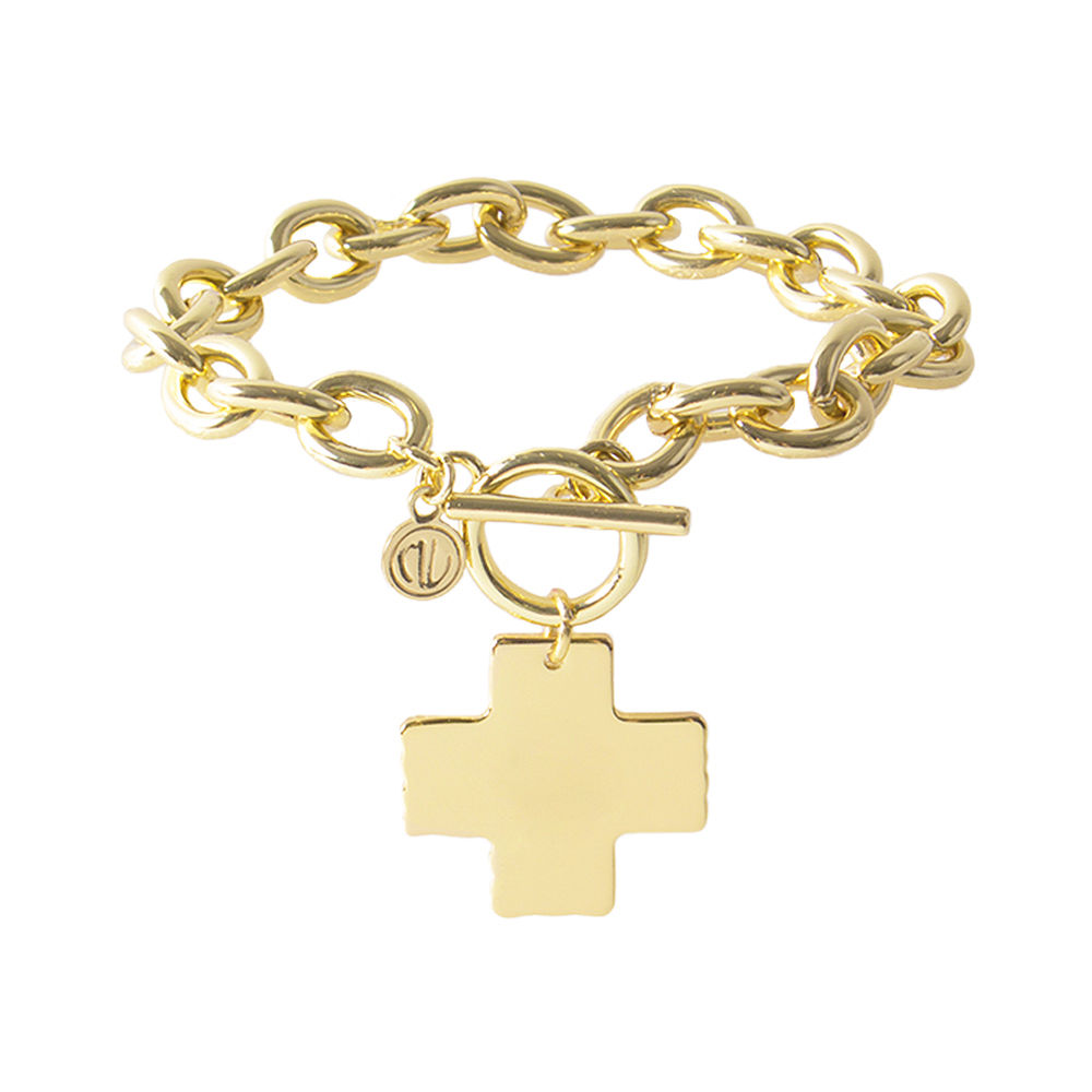 gold chain bracelet with monogrammed cross pendant on wrist
