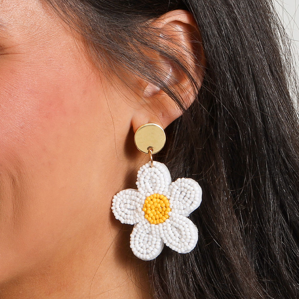 ivory flower earrings in studio