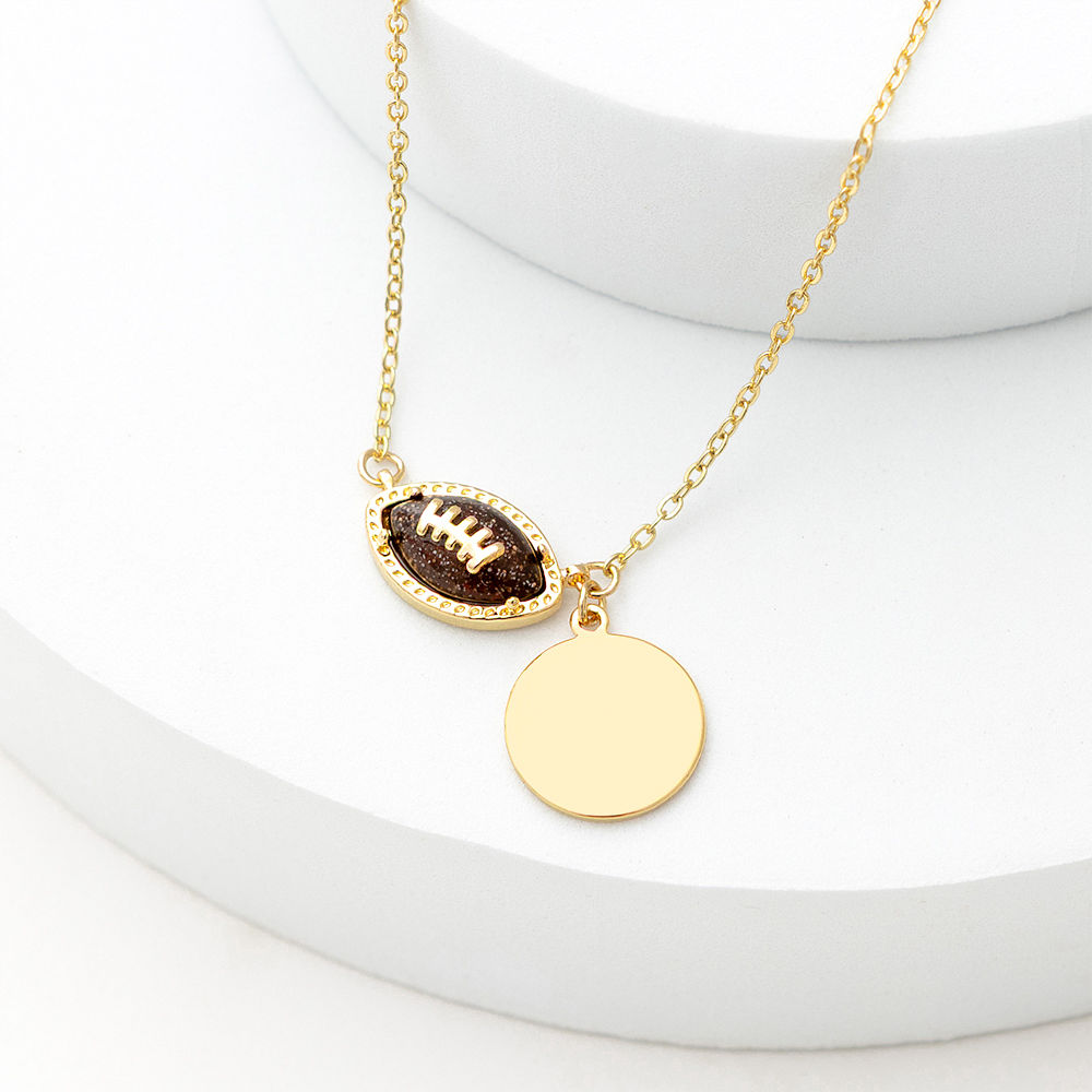 brown football necklace on football