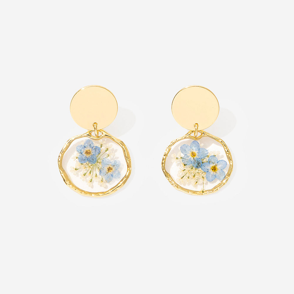 Forget me not earrings with flowers flatlay