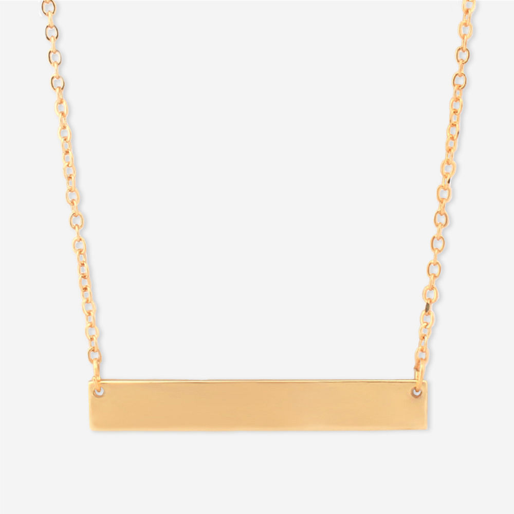 gold monogrammed bar necklace in hands
