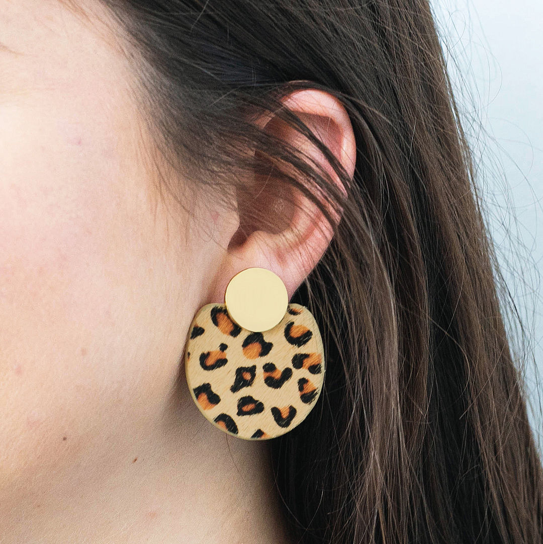 leopard statement earrings in ear