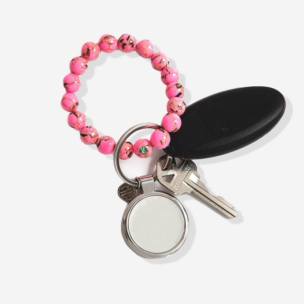 girl holding pink monogrammed marble key ring