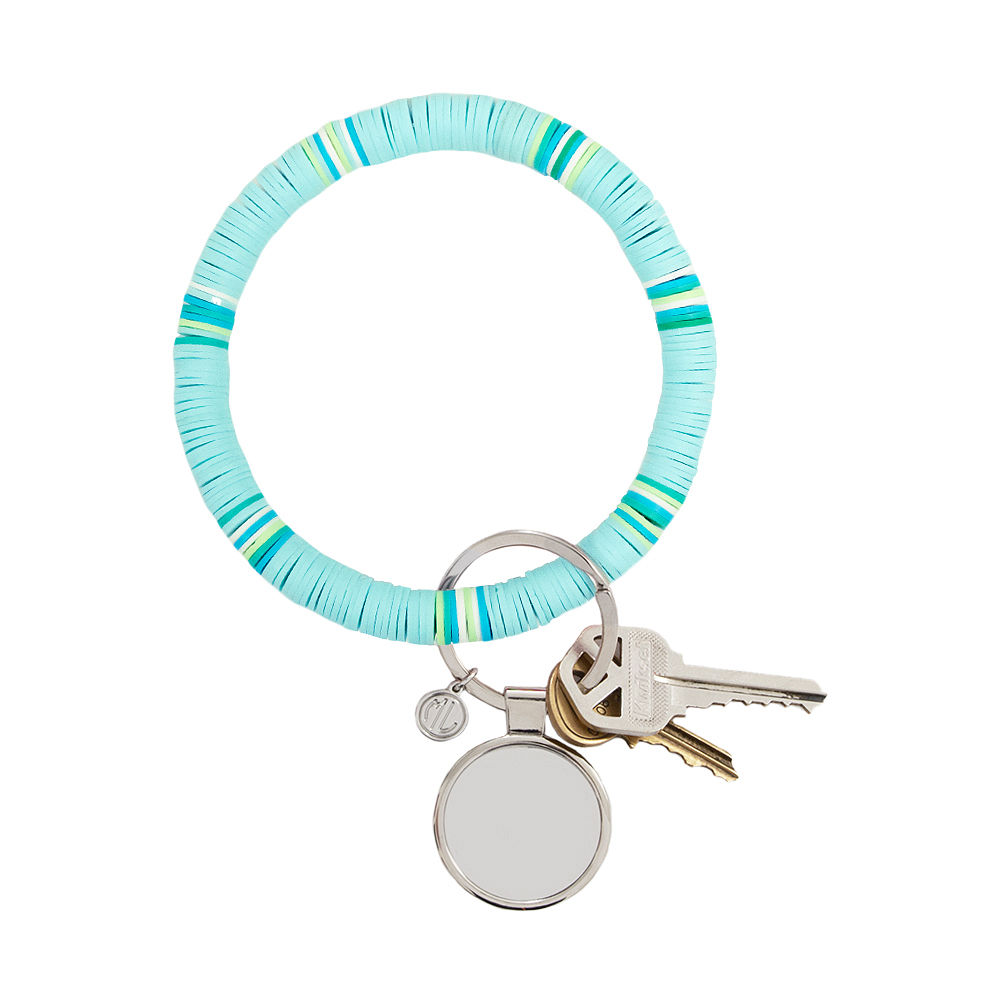 blue mint key ring in hand with keys