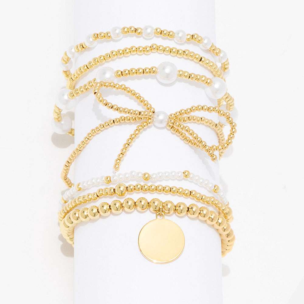 gold pearl bow monogrammed bracelet stack scattered