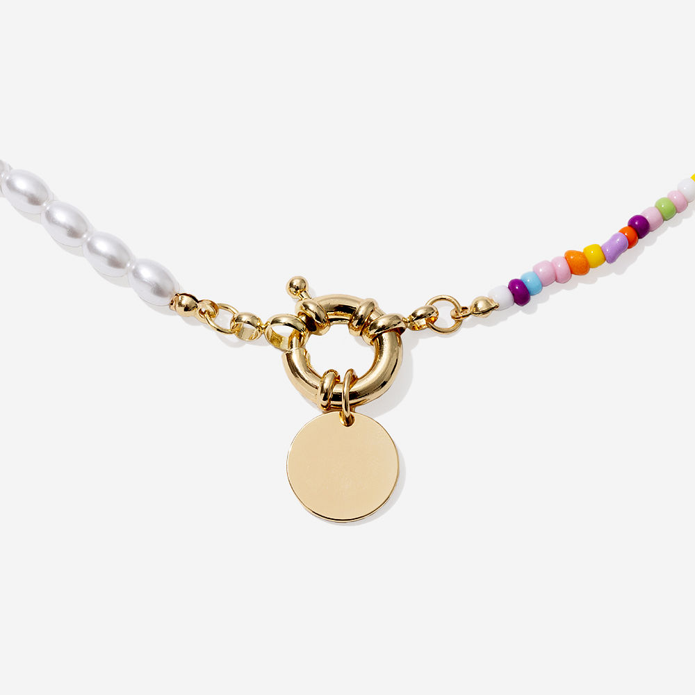 pearl bead seed necklace around neck in sweater