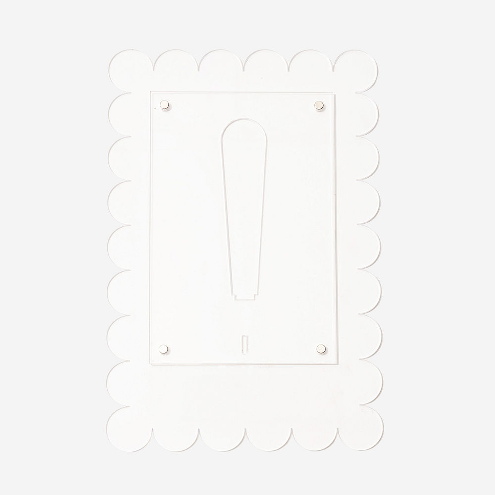 family photo in scalloped picture frame on nightstand