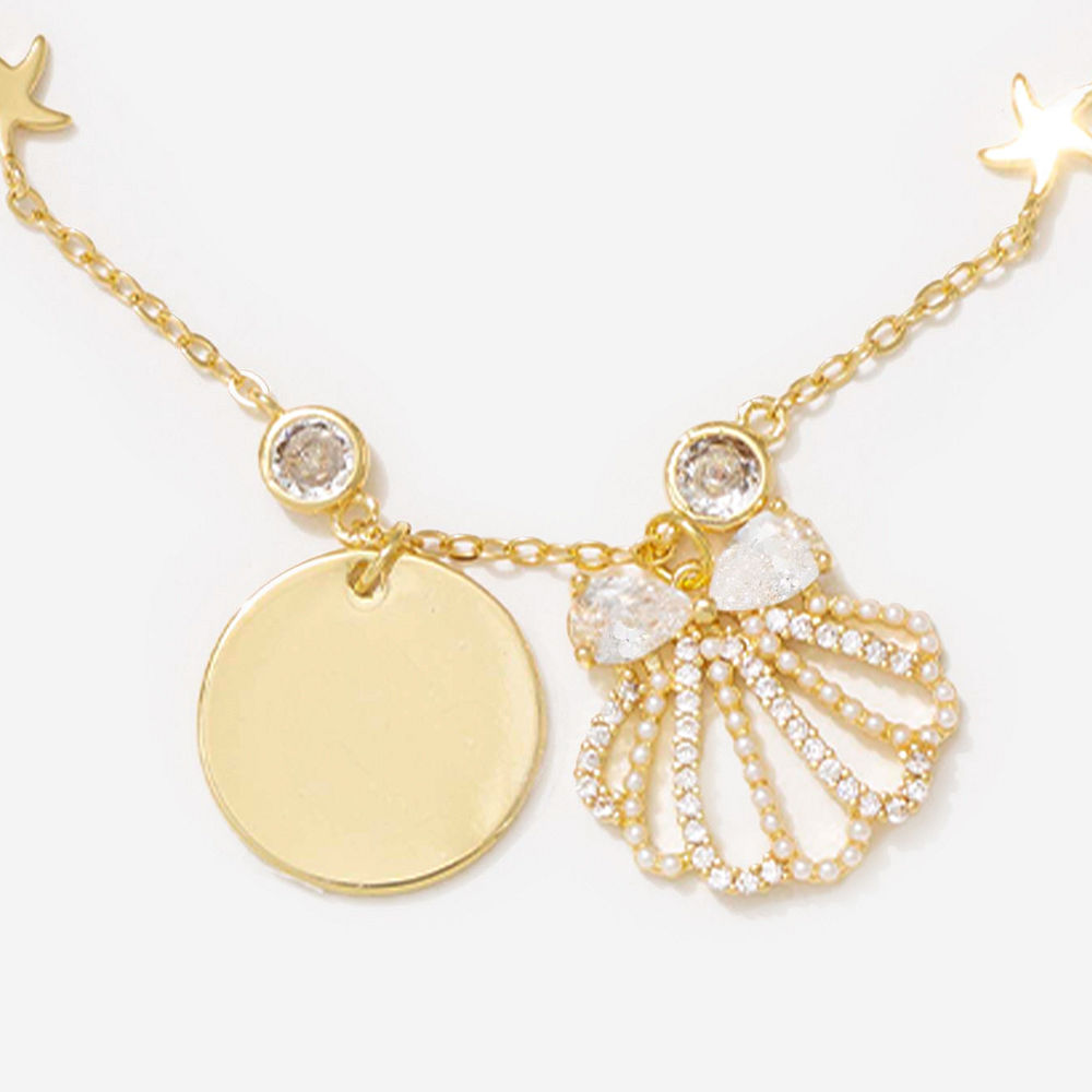 gold shell bracelet set on arm