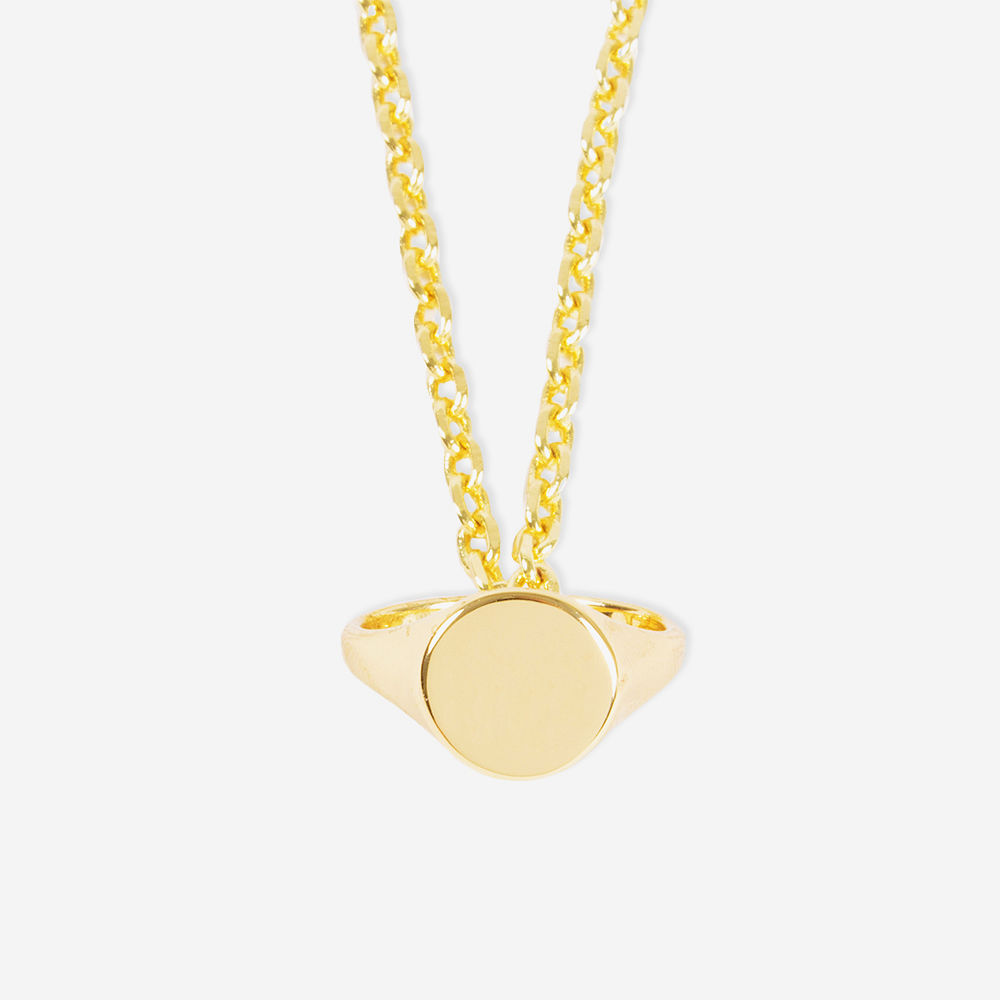girl holding gold signet ring necklace