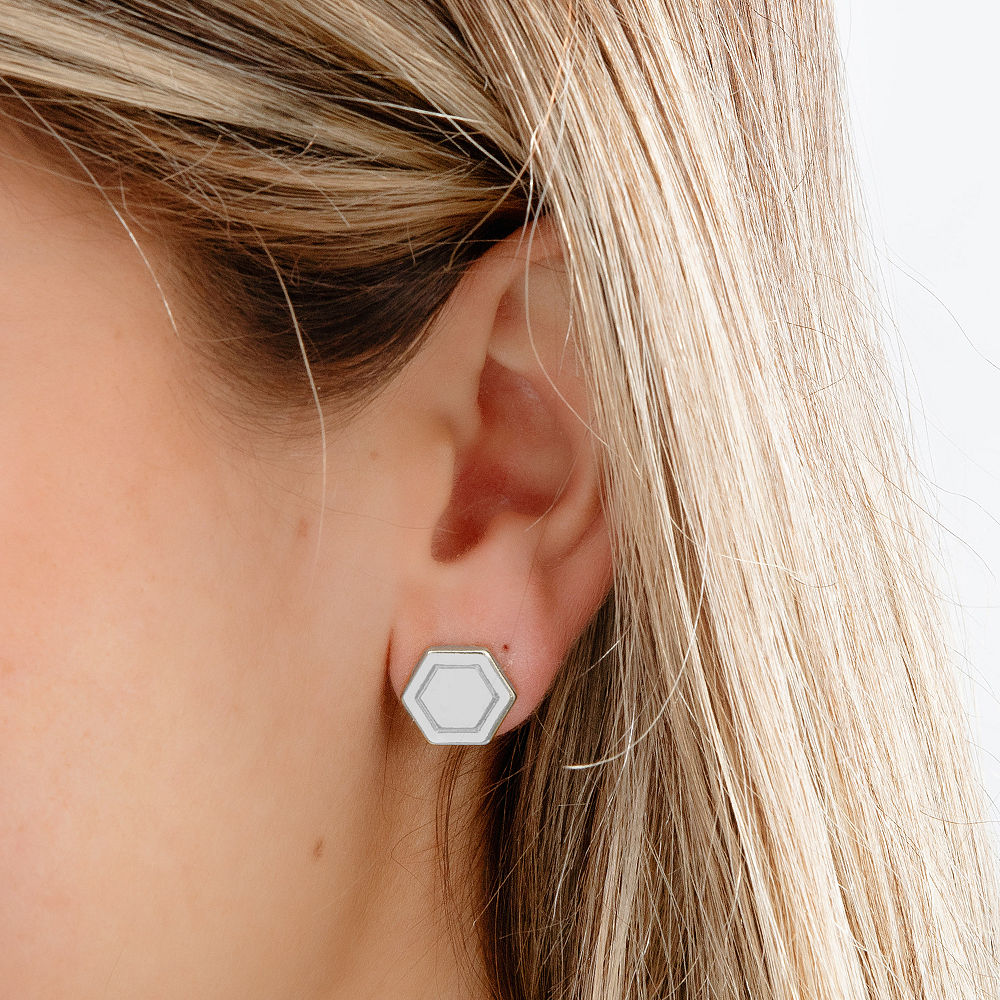 silver hexagon studs in hand