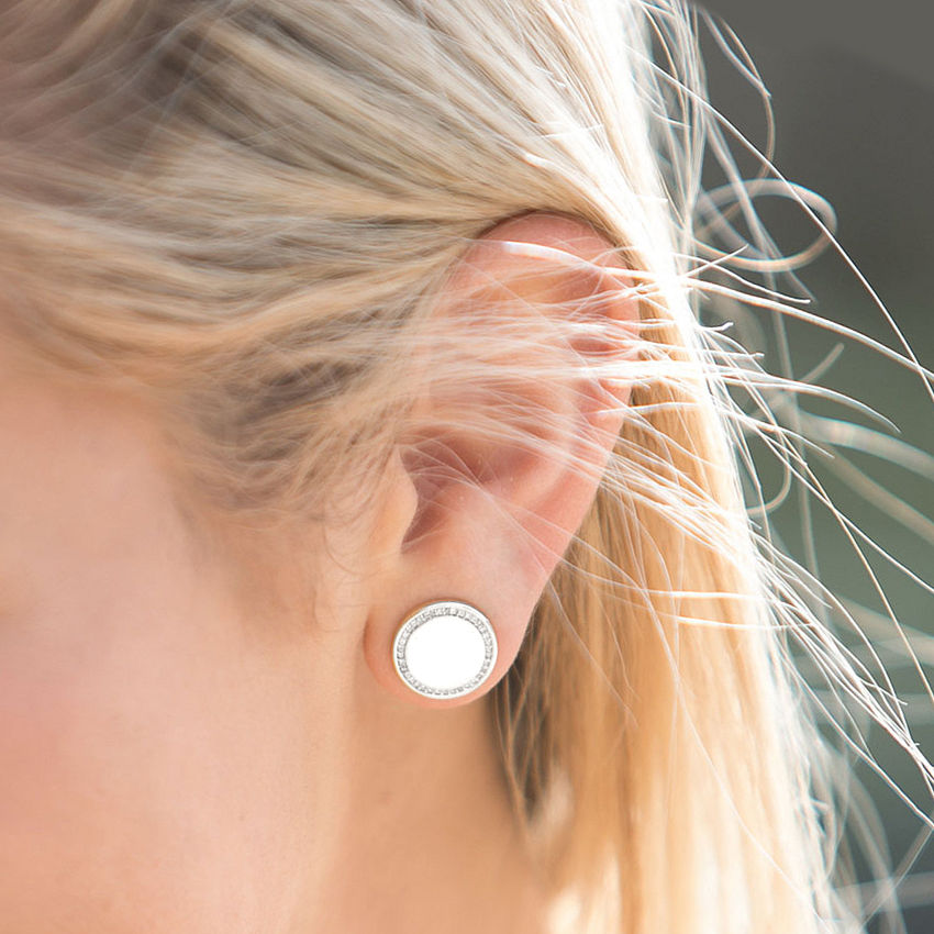 gold and silver earrings on marble dish