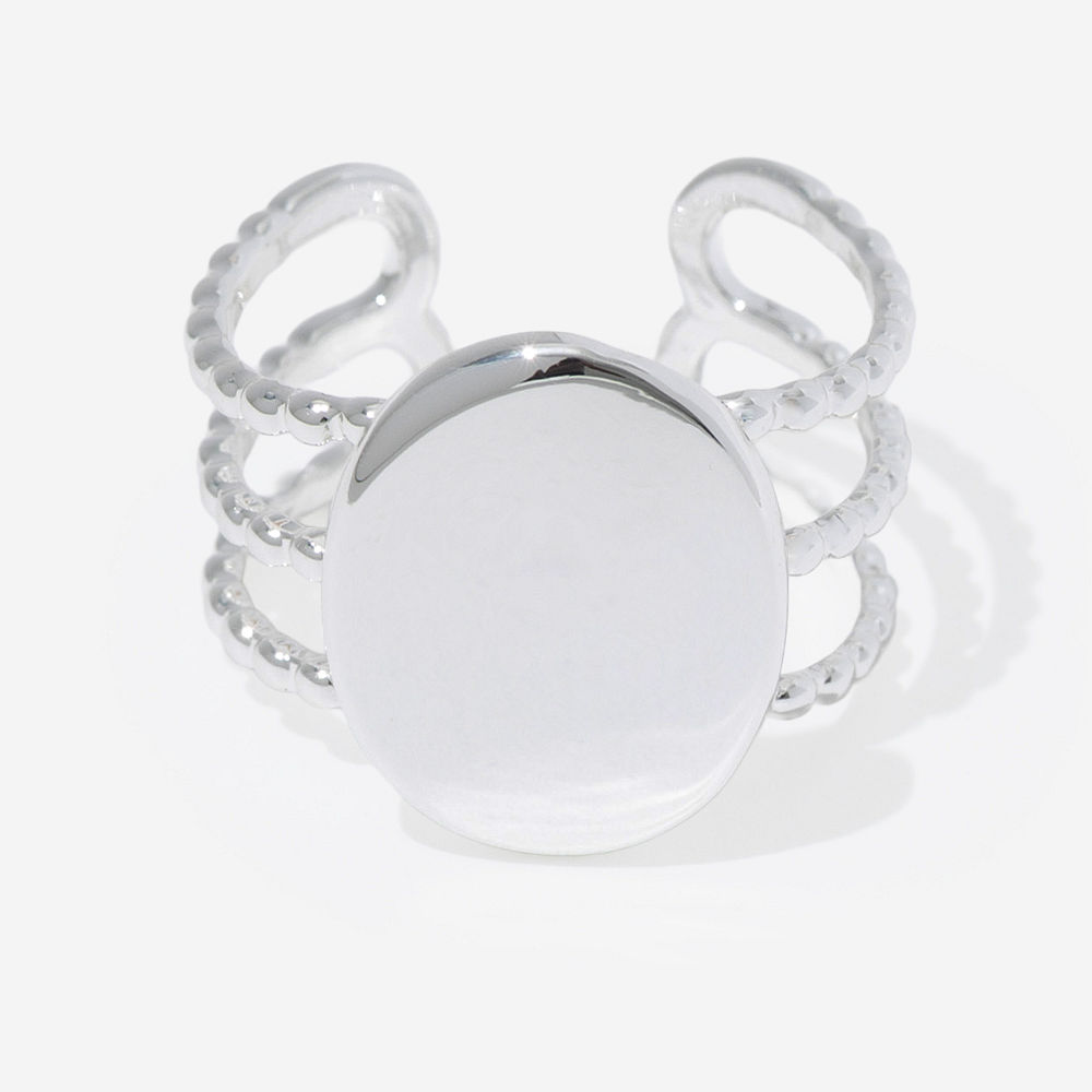 golden statement monogrammed ring on finger