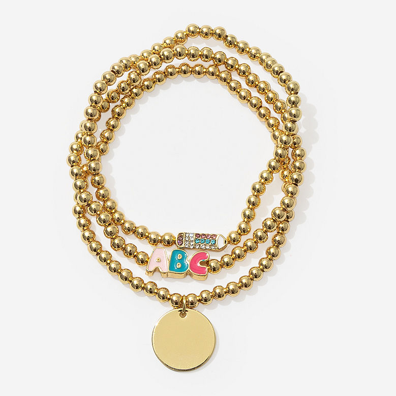 teacher writing on white board with monogrammed gold teacher bracelet beaded stack