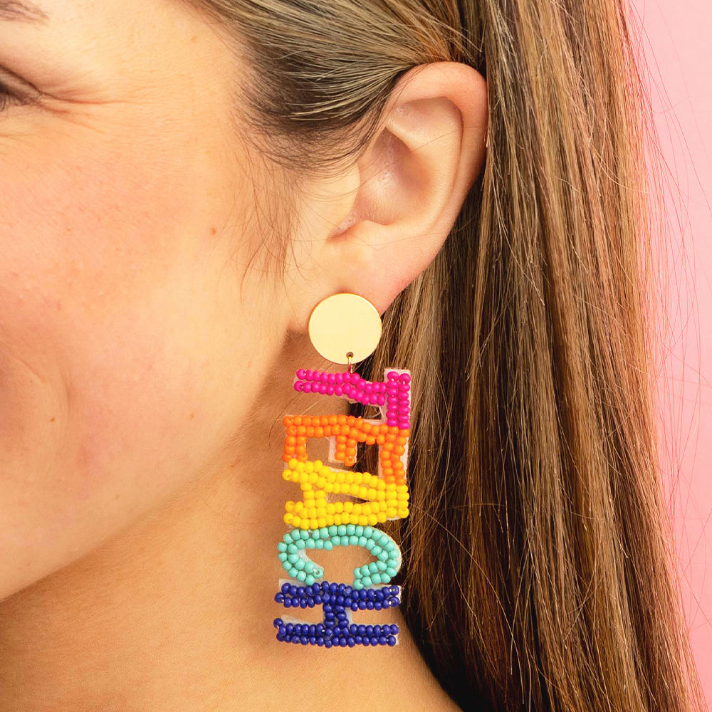 multi teacher earrings on marble dish