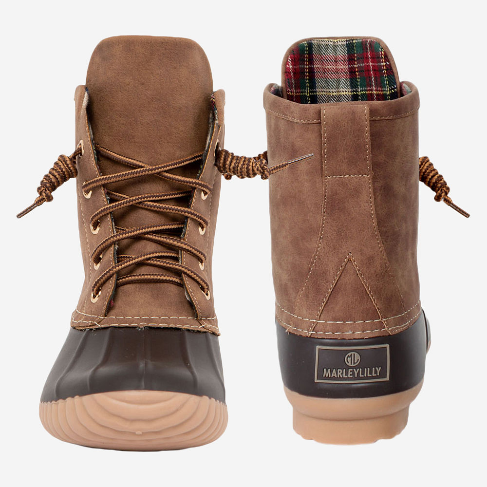 brown monogrammed duck boots in grass