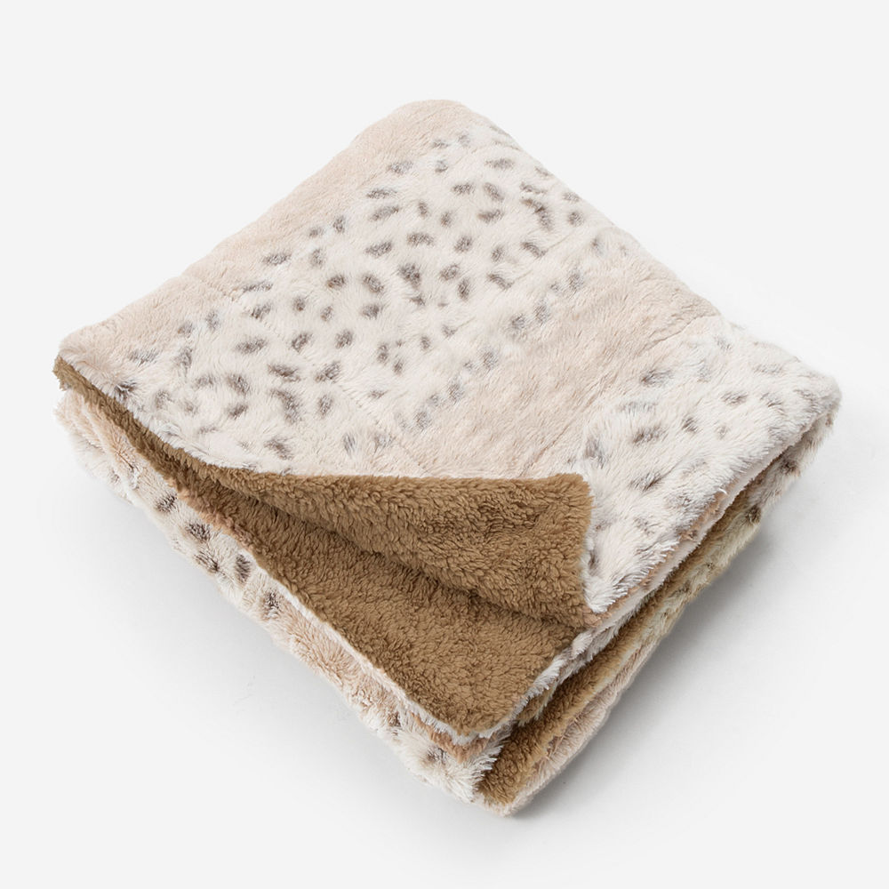 monogrammed khaki fuzzy blanket on couch