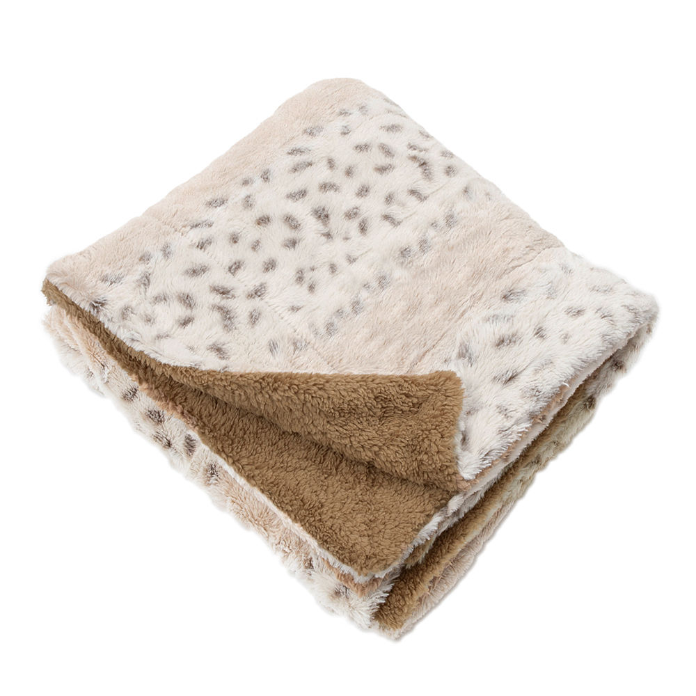 monogrammed khaki fuzzy blanket on couch