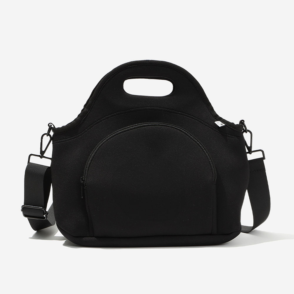 black neoprene lunch bag on desk