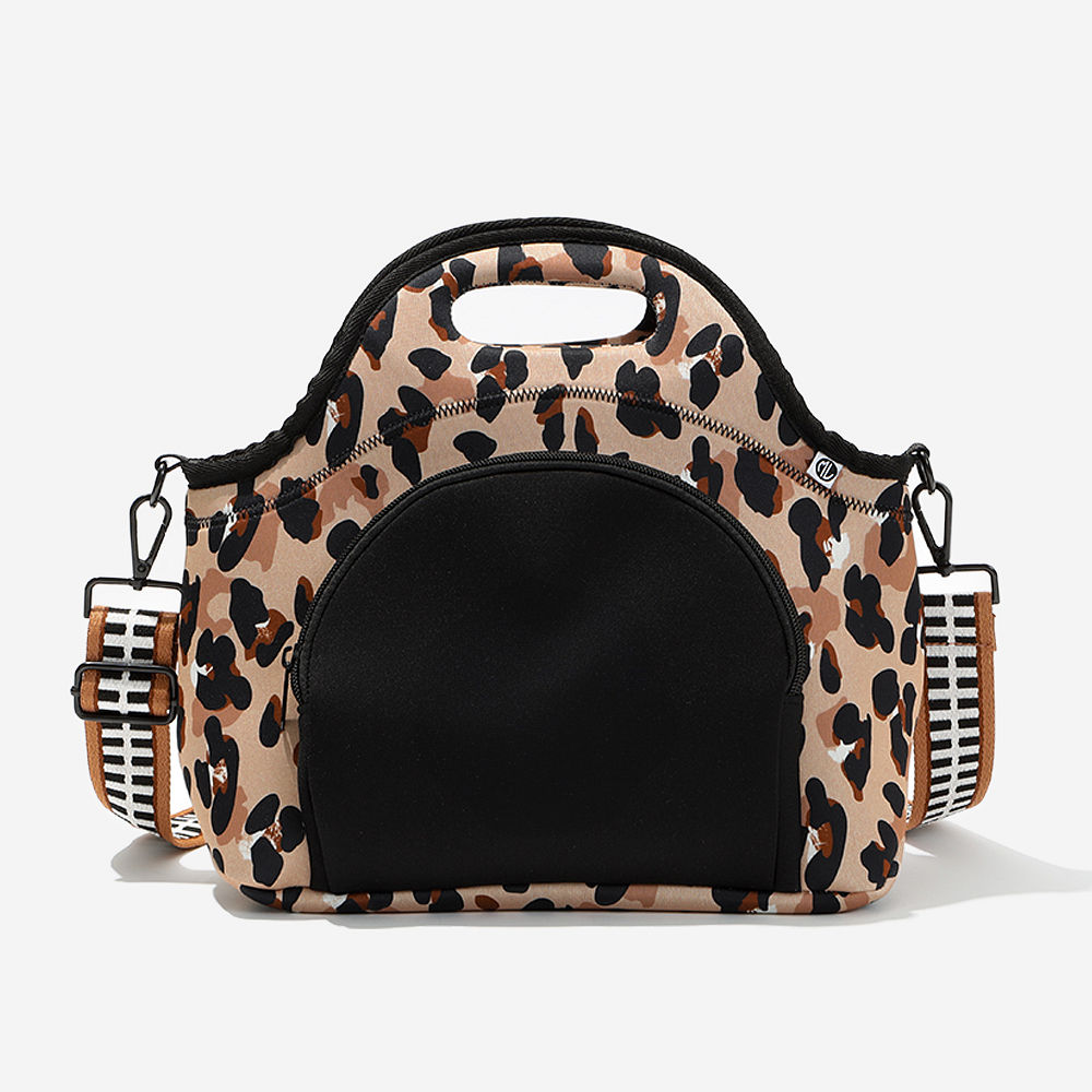 black neoprene lunch bag on desk