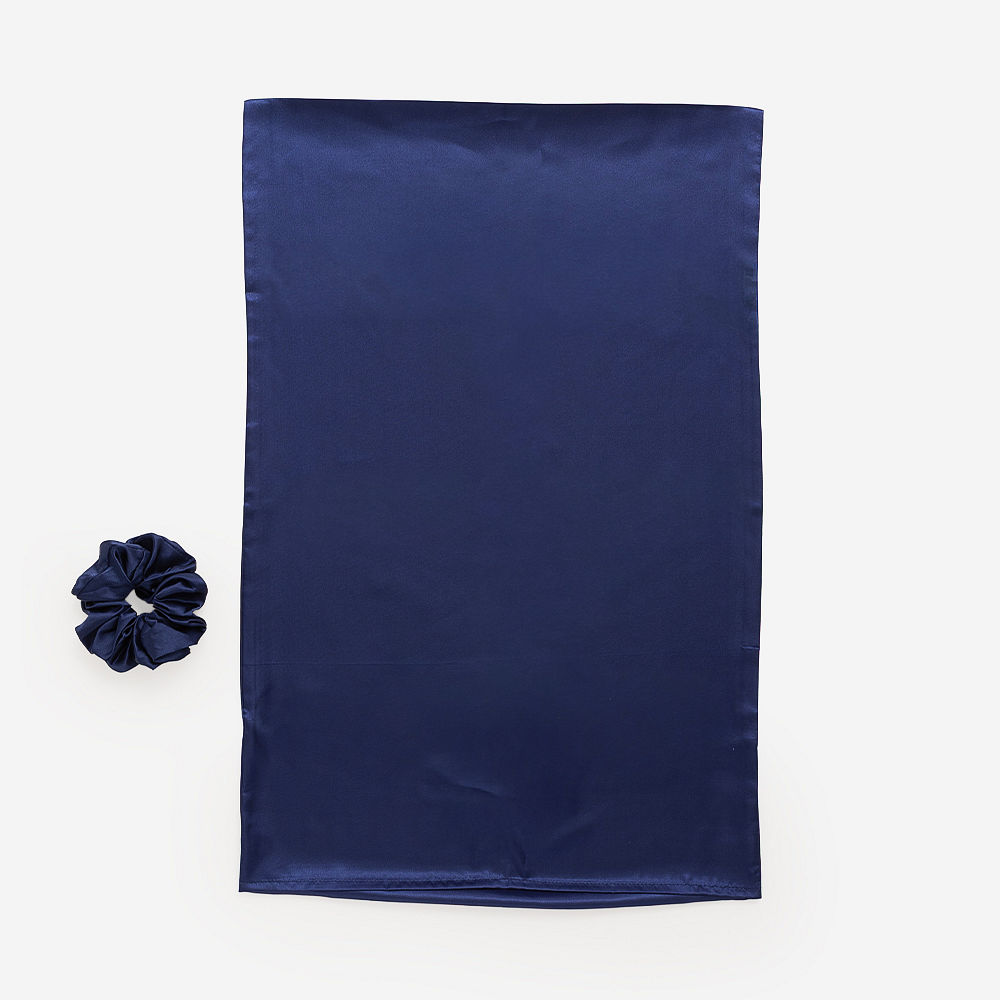 navy silk scrunchie and pillowcase on wrist