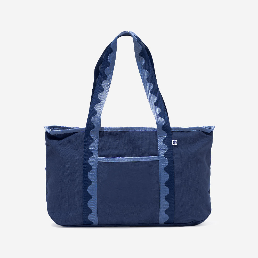 purple anywhere tote bag on bench with flowers