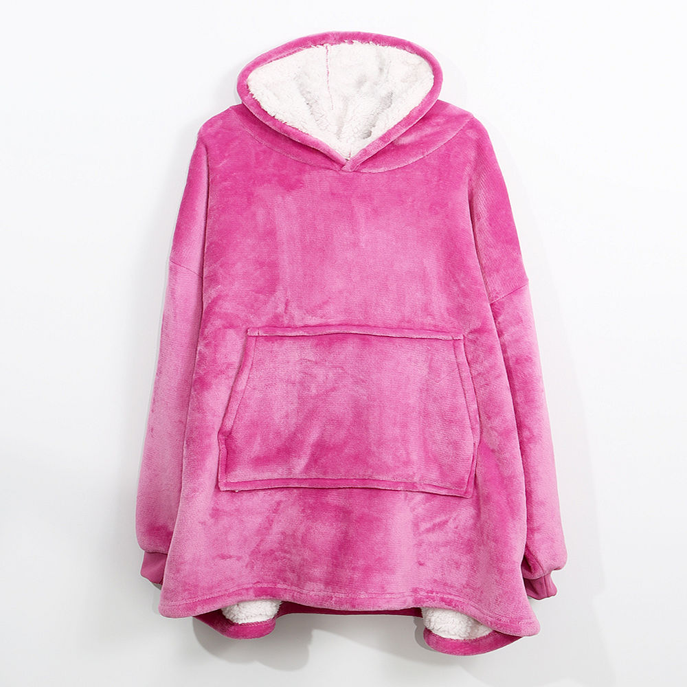 pink blanket hoodie by the fireplace