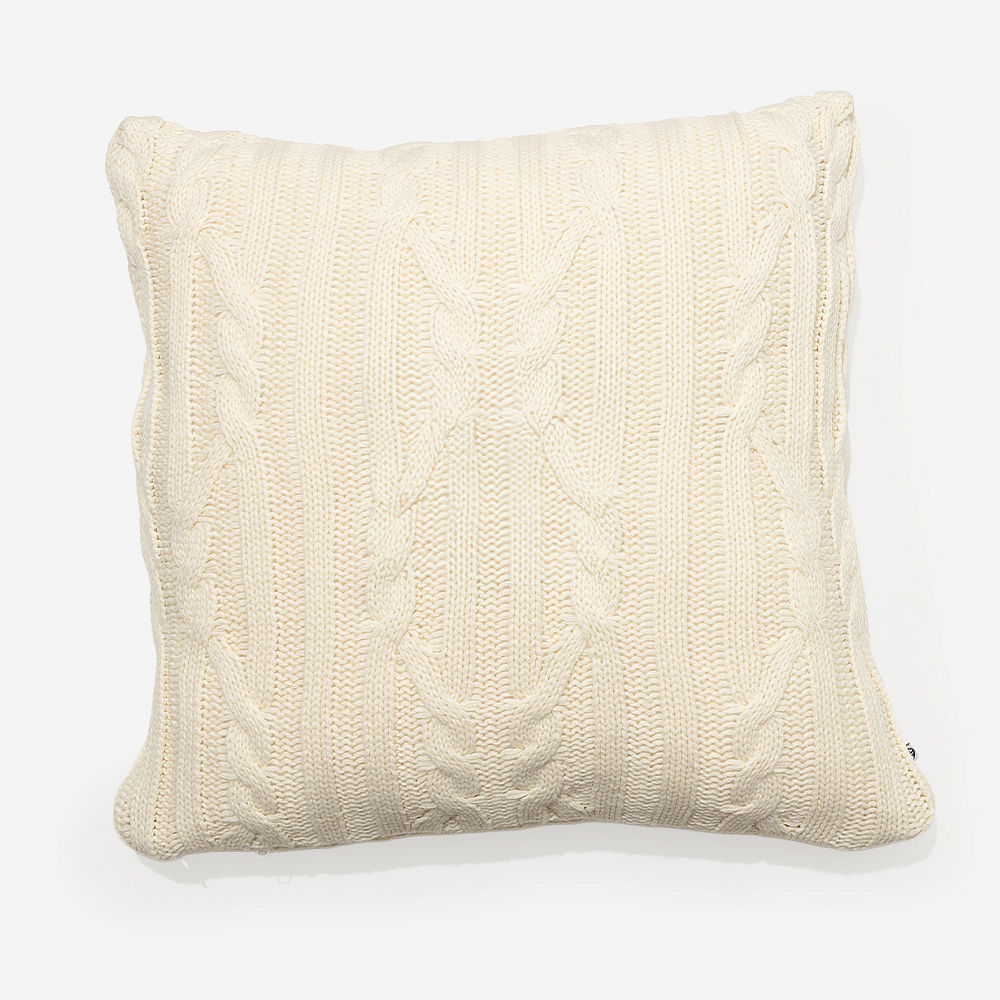 tan cable knit pillow sham on chair